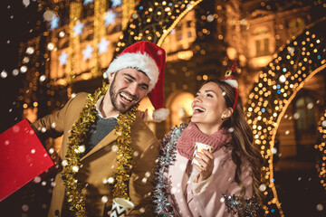 Young romantic couple is having fun outdoors in winter before Christmas.