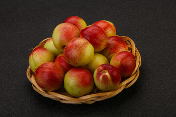 Sweet small nectarines in the basket