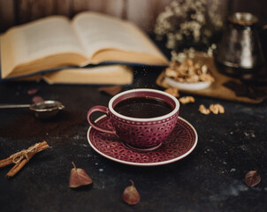 cup of coffee and old open books