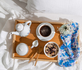breakfast in bed, tray with cup of coffee and oatmeal