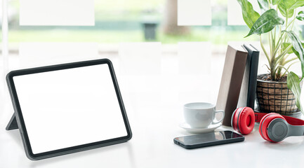 Mockup blank screen portable tablet and gadget on white top table.