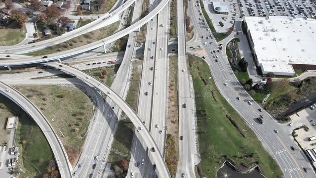 Drone shot panning down to revealing the city at the crossroad intersection between I-64 and I-170 in St. Louis, MO