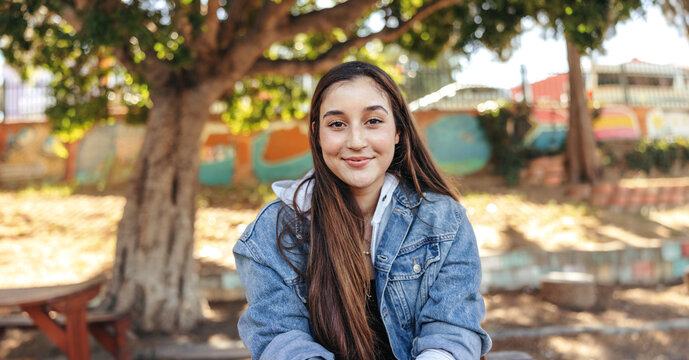 Confident teenage girl looking at the camera with a smile