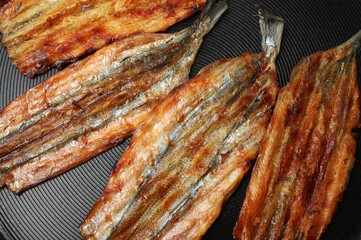 Dried salted fishes on white background