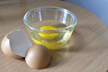 cup of fresh eggs and egg shell
