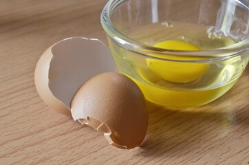 cup of fresh eggs and egg shell
