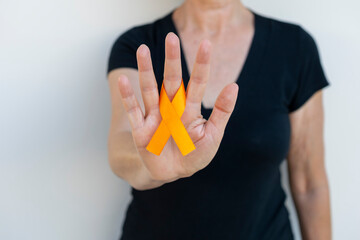 December orange	. woman with orange ribbon on her finger. campaign to prevent skin cancer,...