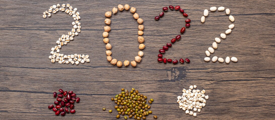 2022 New Year and New You with organic Beans; red, black, white, green, chickpeas and Adlay on table. Goals, Healthy, Motivation, Resolution, Weight loss, dieting and world food day concept