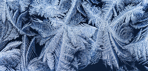 Winter background, frost on window. Winter frosty blue patterns on the glass