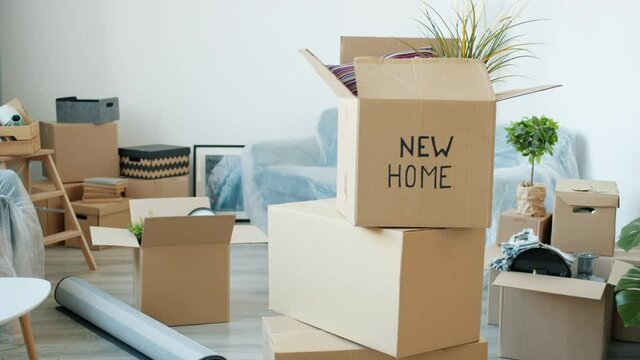Light studio with cardboard boxes full of belongings during relocation while no people are visible in background. Moving to new apartment concept.