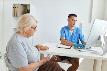Obraz na płótnie Canvas an elderly woman is examined by a doctor health care