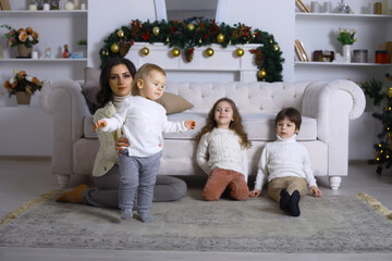 A young family with children decorates the house for the holiday. New Years Eve. Waiting for the new year.