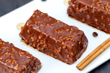 cake with peanuts poured with chocolate c