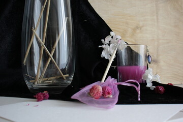Beautiful composition in purple. Artist. Dried flowers, brush, glass, cloth, wood