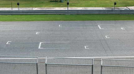 Empty asphalt race track starting point background. 