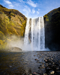 Fototapeta na wymiar Icelandic Landscape. Classic long exposure view of famous Skogafoss waterfall with colorful sky during sunset. Skoga river, highlands of Iceland, Europe. 