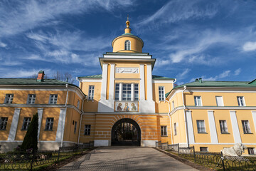 View of the southern gate with the gateway church of St. Mitrofan of the Voronezh Pokrovsky Khotkov monastery in autumn. Khotkovo, Moscow region, Russia