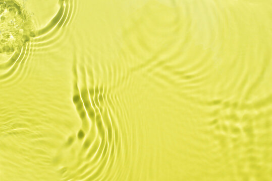 Banner or background for advertising cosmetics with yellow green water spills. Natural sunlight and shade. Beautiful bursts and glare. Summer mood. Minimal style.