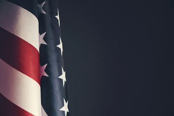 Standing flag United States of America on dark gray background.Banner of America in retro style.