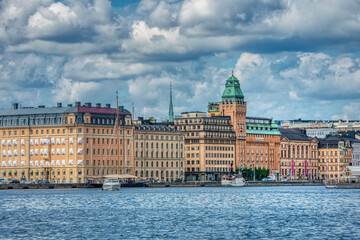 Detail of the Stockholm beautiful and touristic Gamla Stan or old town with its colourful buildings. Detailed view of the city 's historical harbour (Nybroviken havn) - Stockholm, Sweden