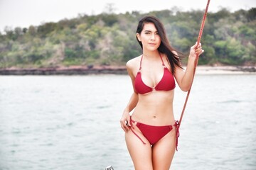 portrait sexy asia woman wear bikini on the yacht