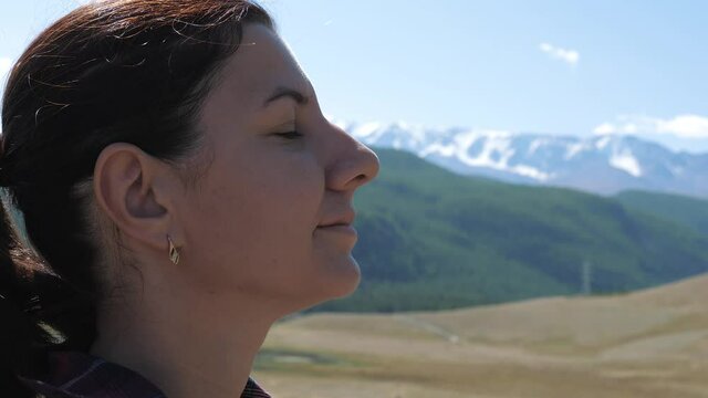 Close-Up Woman Meditating In Mountains Taking A Deep Breath Of Clean Air