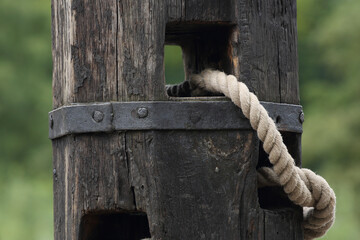 A close-up of a mooring post and rope
