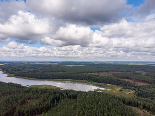 Fototapeta premium Areal drone photography view of countryside forest and small lake.