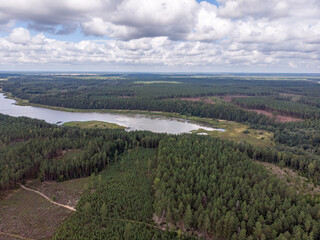 Areal drone photography view of countryside forest and small lake.