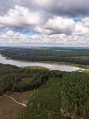 Areal drone photography view of countryside forest and small lake.