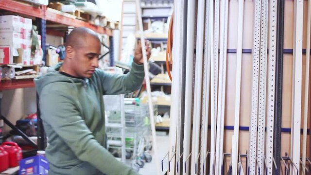 Man buys plastic corners for repair in a hardware store