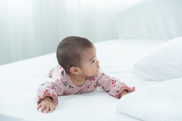 Fototapeta premium Little baby girl laying on the bed 