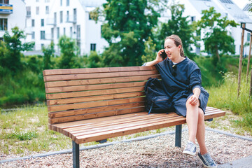 Fototapeta premium Candid young woman talking by phone