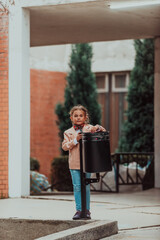 Quarantine is over concept. Girl throwing away protective face mask to garbage trash can on background of blooming park.End of covid-19 pandemic,freedom,victory,win. Selective focus.