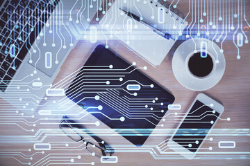 Double exposure of technology theme drawing over work table desktop. Top view. Global data analysis concept.
