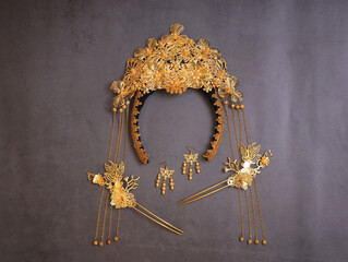 Chinese traditional hairpins hair clips on a grey concrete background. Traditional Chinese women's jewelry, gold hairpins with red gems