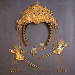 Chinese traditional hairpins hair clips on a grey concrete background. Traditional Chinese women's jewelry, gold hairpins with red gems