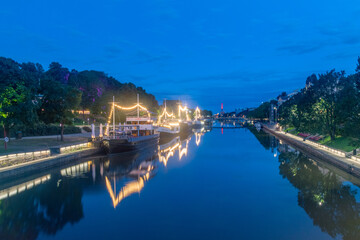 Turku, Finland - August 5, 2021: Night view on Aurajoki river with illuminated ships.