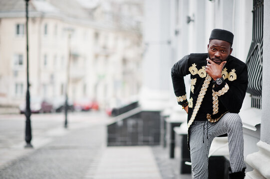 Mega Stylish African Man In Traditional Jacket Pose. Fashionable Black Guy In Hat.