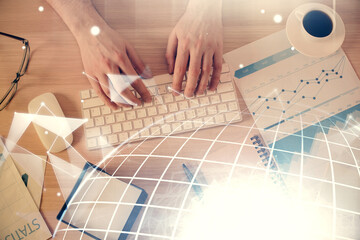 Multi exposure of man's hands typing over computer keyboard and world map hologram drawing. Top view. Technology concept.
