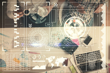 Double exposure of man and woman working together and data theme hologram drawing. Computer background. Top View.