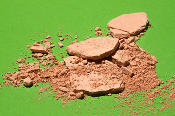 Face powder. Broken pieces of cosmetic powder. Cosmetic smear.