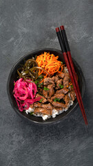 Bulgogi with meat on dark background.