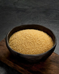 Couscous on dark background.