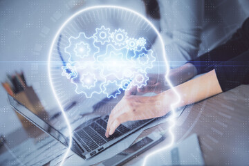 Multi exposure of woman hands working on computer and brain hologram drawing. Ai concept.