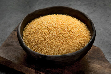 Couscous on dark background.