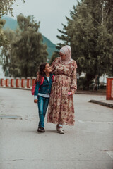 a Muslim mother returns from school with her daughter. Selective focus