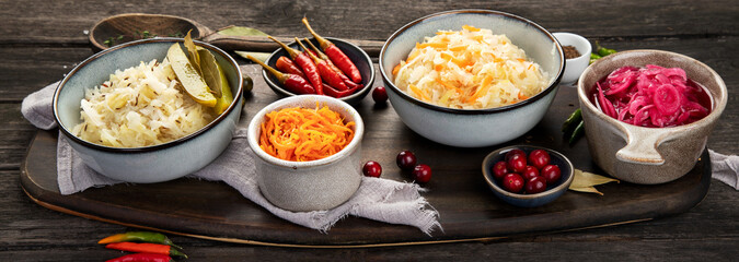Pickled vegetables on wooden background. Salting vegetables.