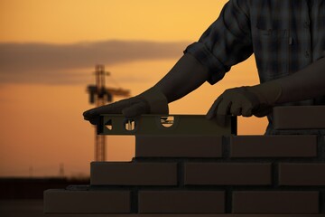 Silhouette construction mason worker bricklayer, construction laying bricks