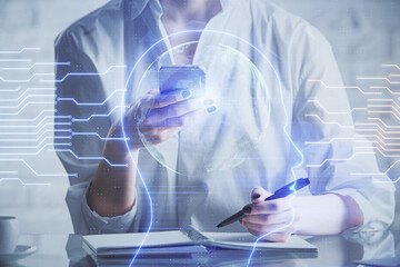 Double exposure of brain sketch hologram and woman holding and using a mobile device.